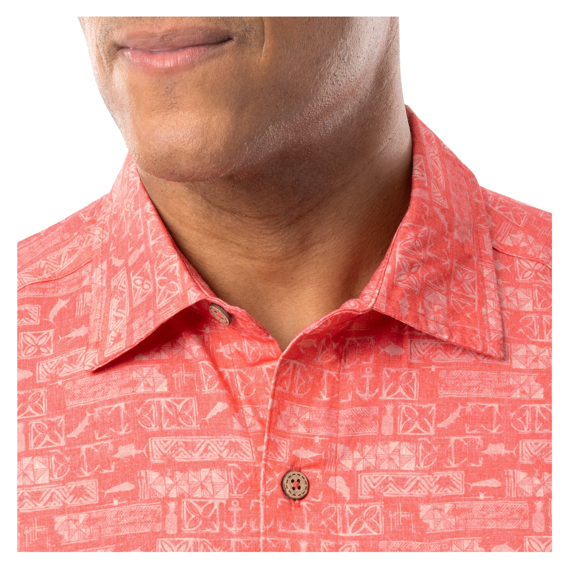 Detail of collar and coconut shell buttons on coral red Guy Harvey Men’s Aztec Printed Resort Shirt.