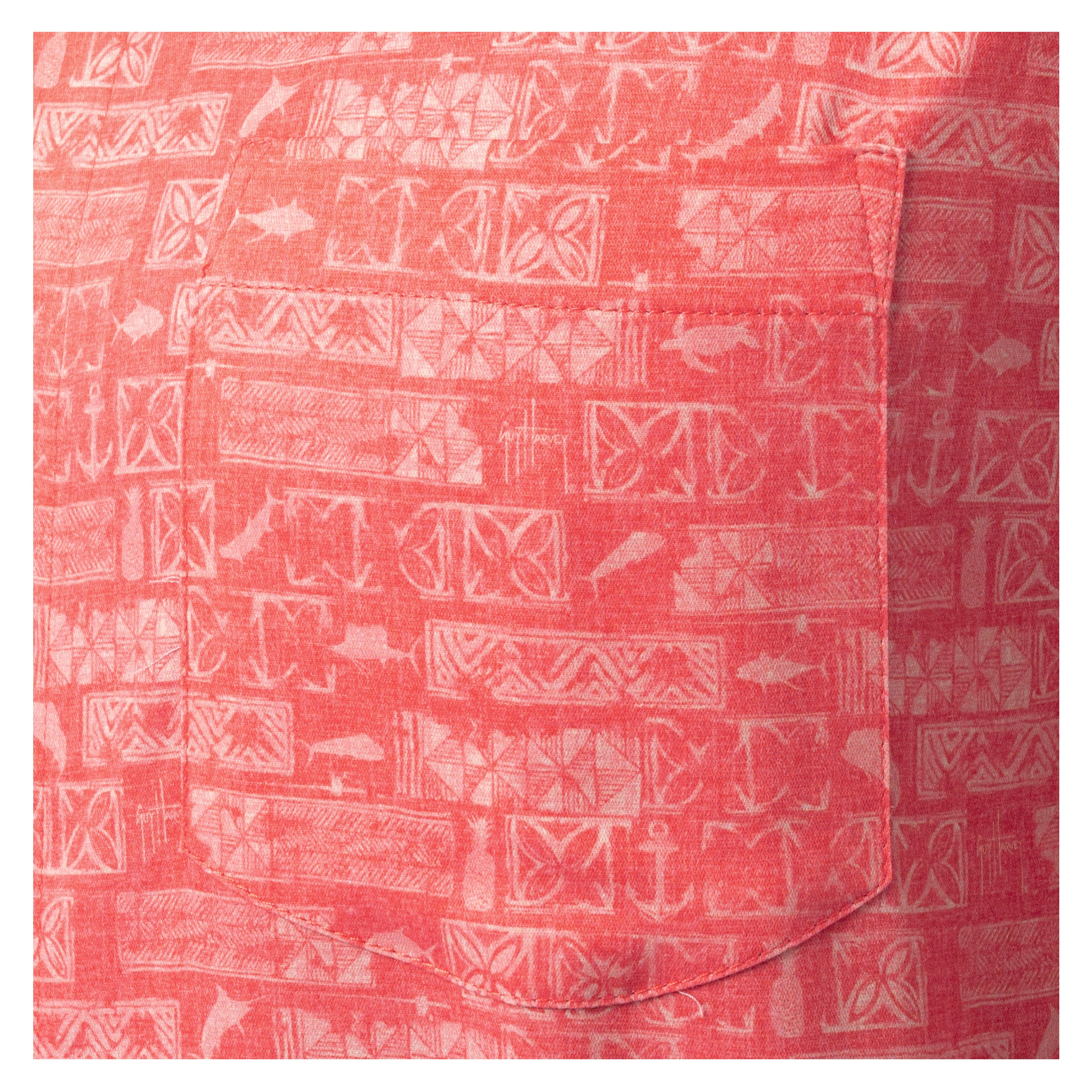 Close-up of left chest pocket with Aztec pattern on coral red Guy Harvey Resort Shirt.