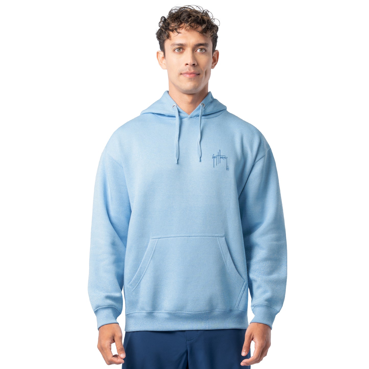 Front view of a man wearing a light blue Guy Harvey fishing fleece hoodie with white Guy Harvey logo on the chest.