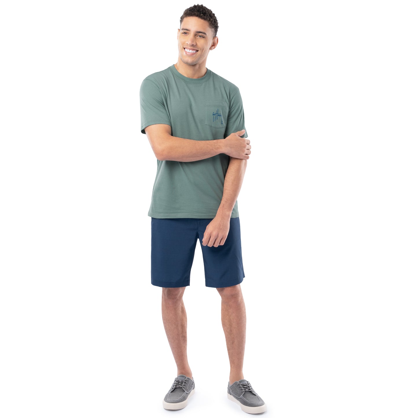 Man wearing a green t-shirt and blue shorts on a white background