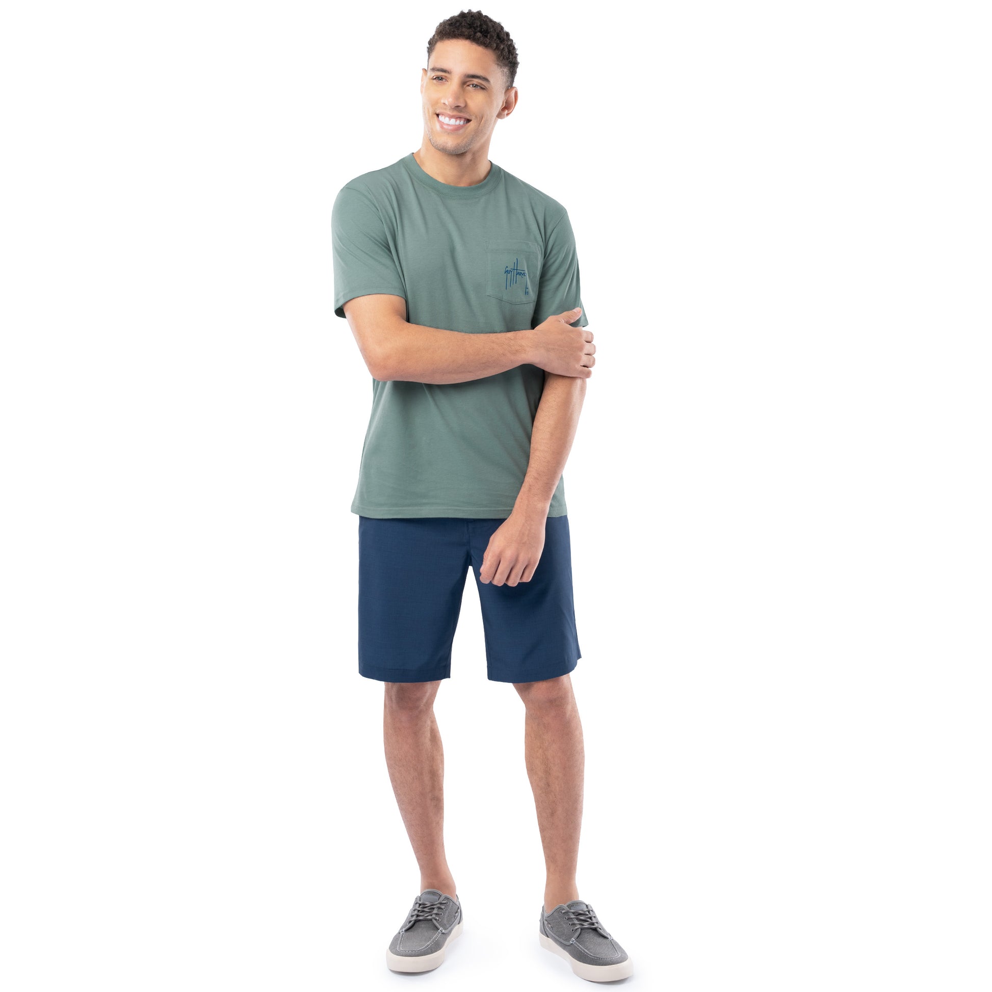 Man wearing a green t-shirt and blue shorts on a white background
