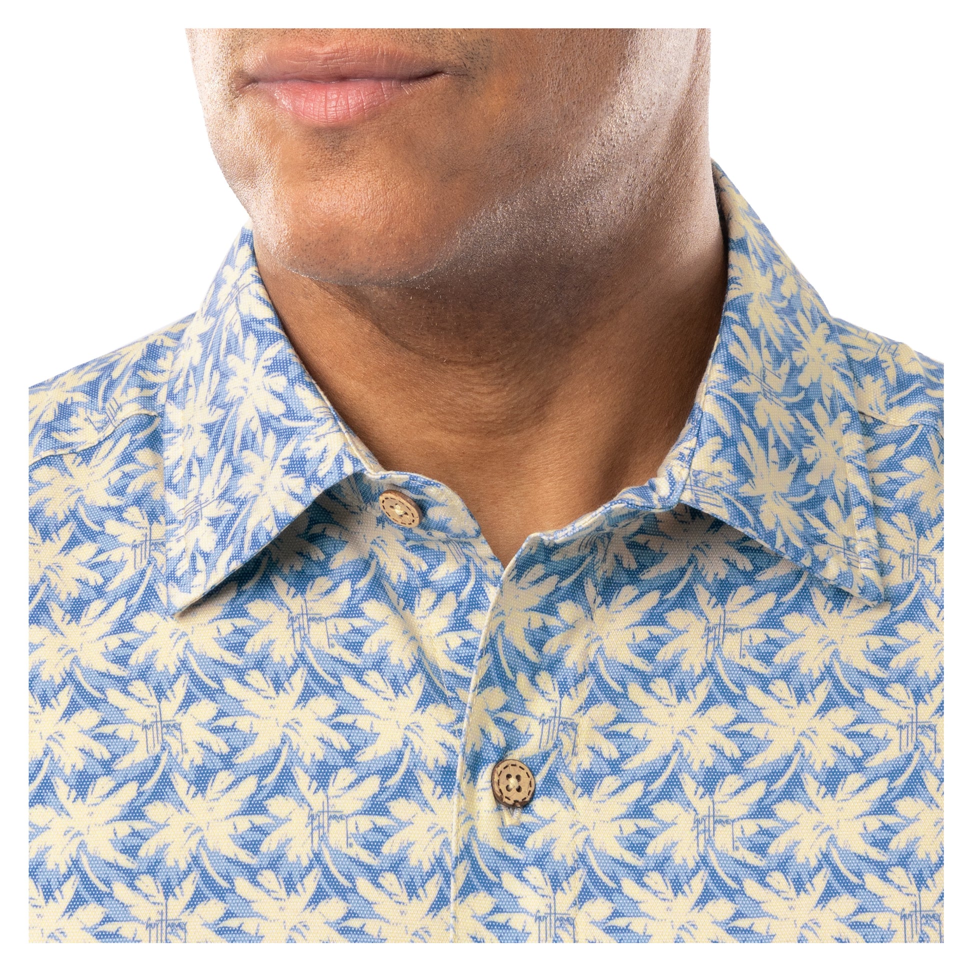 Close-up of collar and coconut shell buttons on blue and sand Guy Harvey Dot Palm Resort Shirt.