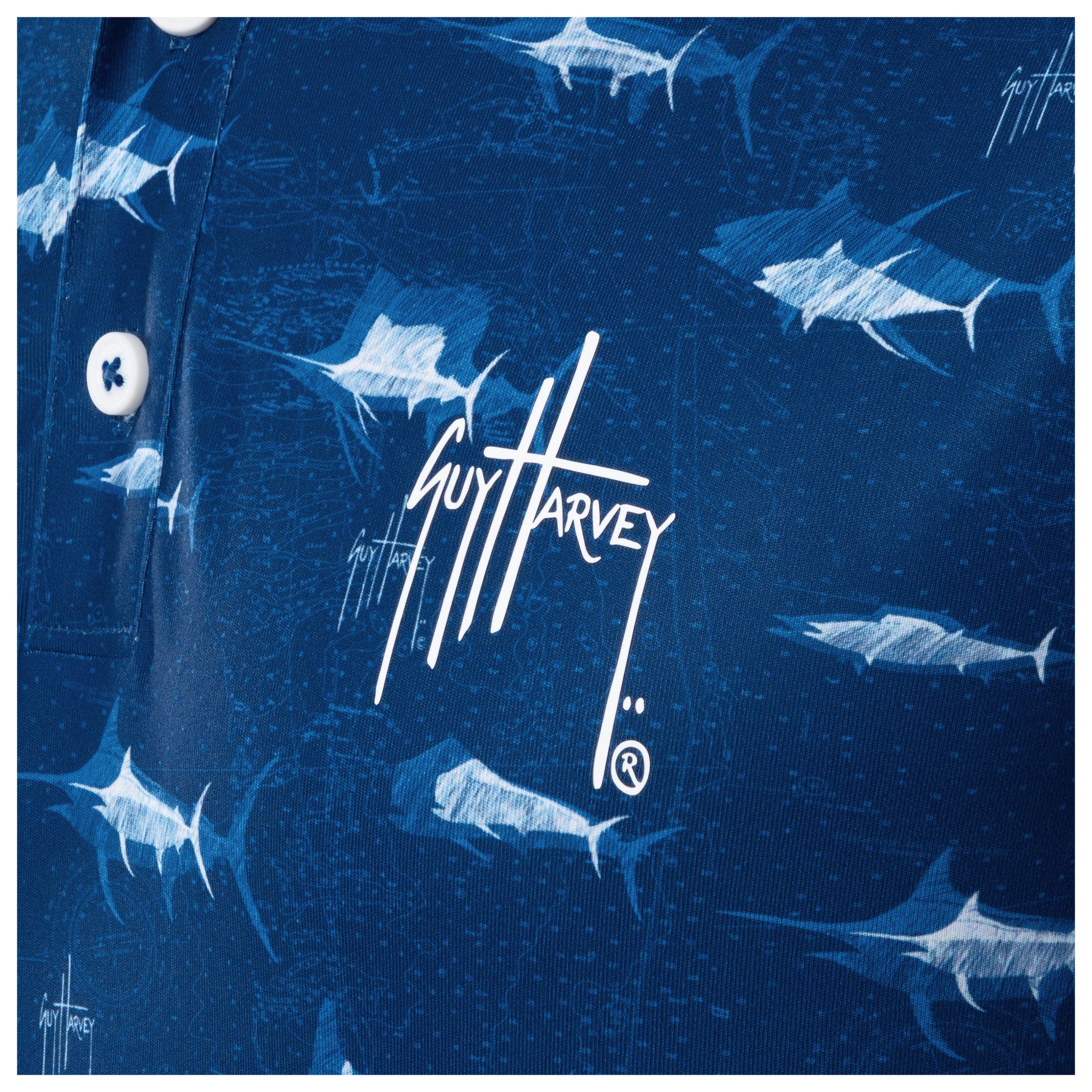 Detail of white Guy Harvey signature logo and marlin print on ocean blue fabric.