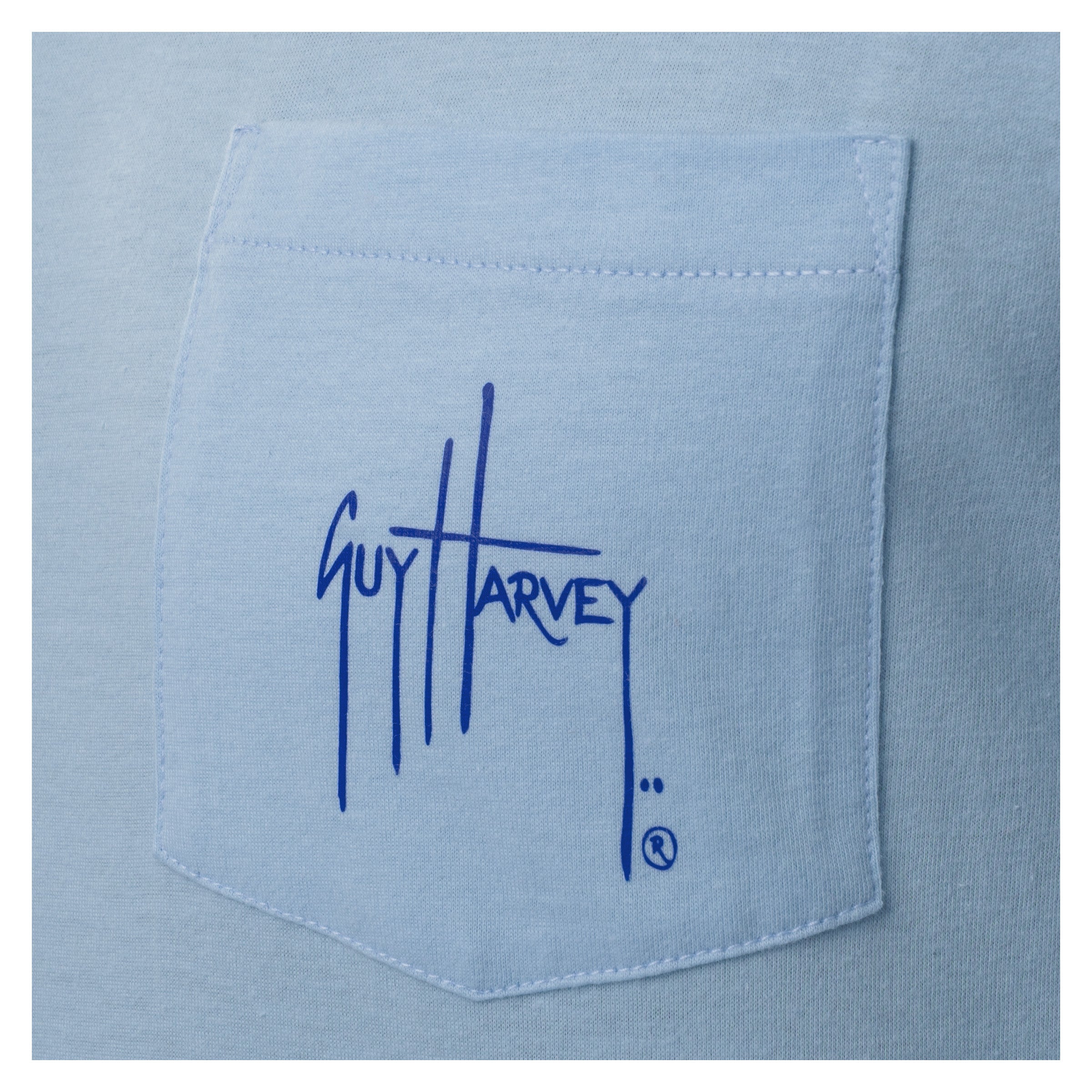 Blue shirt pocket with Guy Harvey logo