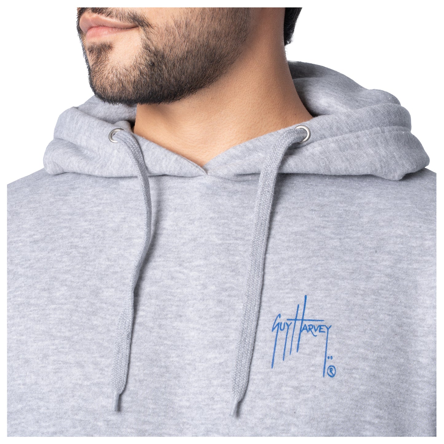 Close-up of the blue Guy Harvey logo on the chest of a light gray fishing fleece hoodie.