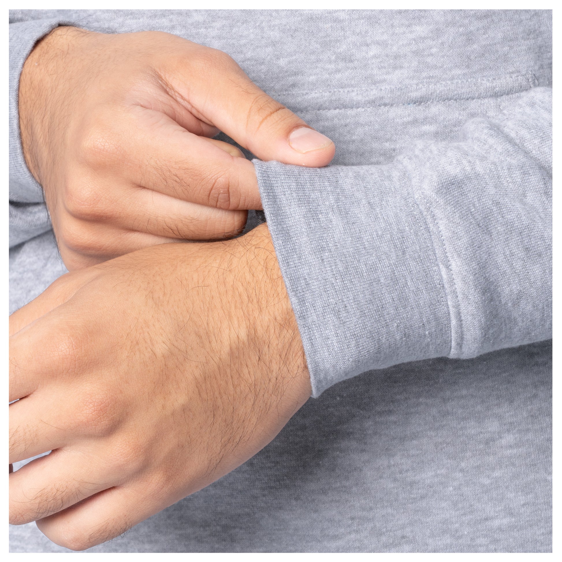 Close-up of sleeve cuff detail on a light gray Guy Harvey fishing fleece hoodie.