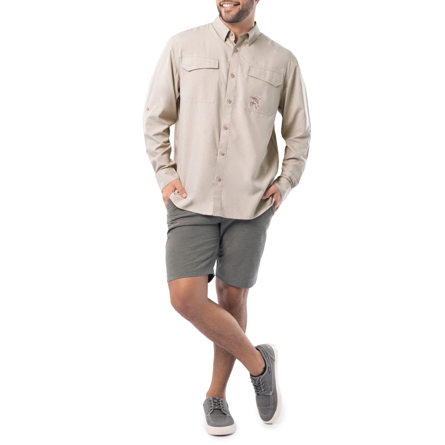 Man wearing a beige button-up shirt and gray shorts on a white background