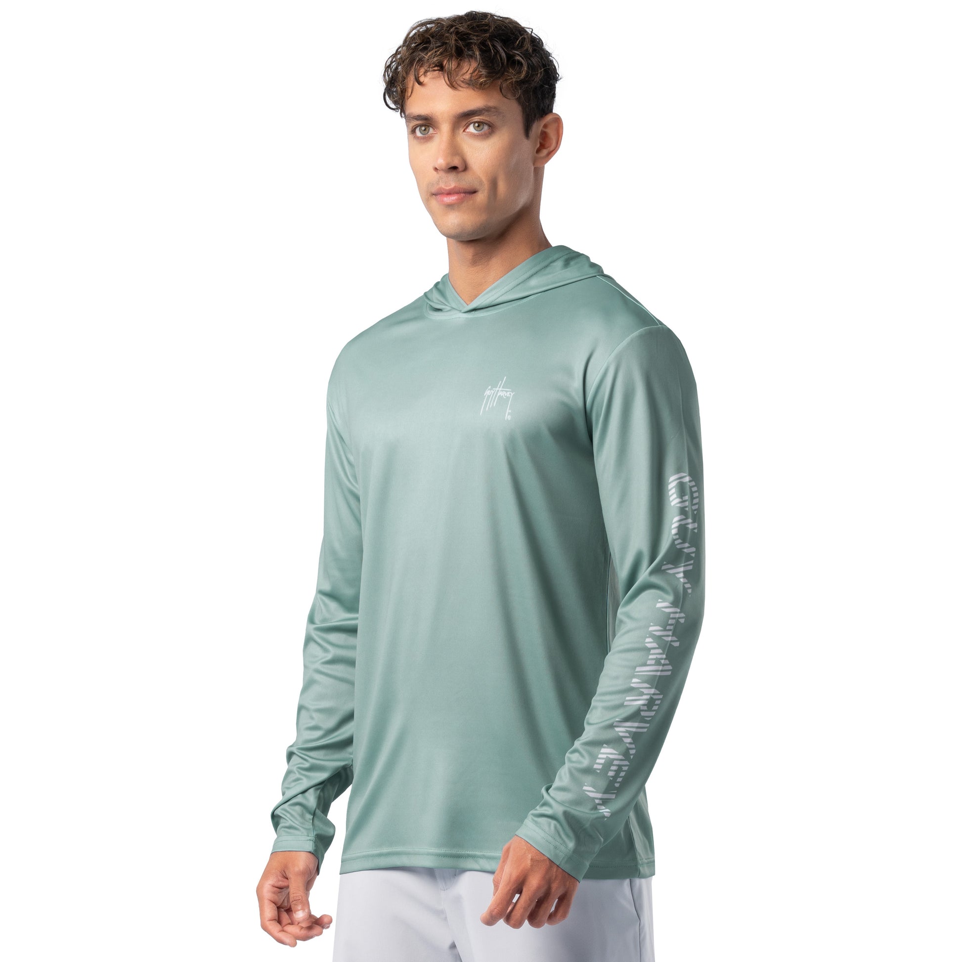 Side view of seafoam green Guy Harvey Men’s Mahi Gear Hoodie highlighting sleeve logo and relaxed fit.
