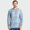 A man wearing a light blue and gray mallard camouflage long-sleeve sun protection shirt, standing against a solid light gray background.