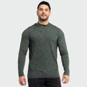 A man wearing a dark green long-sleeve marlin air sun protection hoodie with a subtle tonal pattern, shown against a light gray studio background.