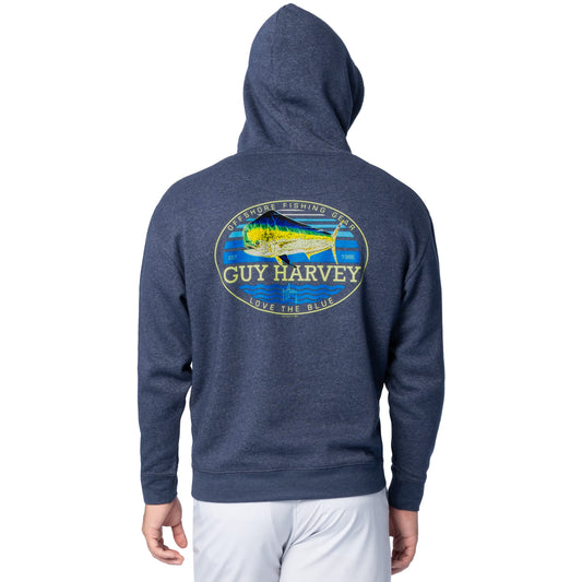 Back view of a man wearing a navy blue Guy Harvey fishing fleece hoodie featuring a colorful mahi mahi artwork with “Offshore Fishing Gear” text.