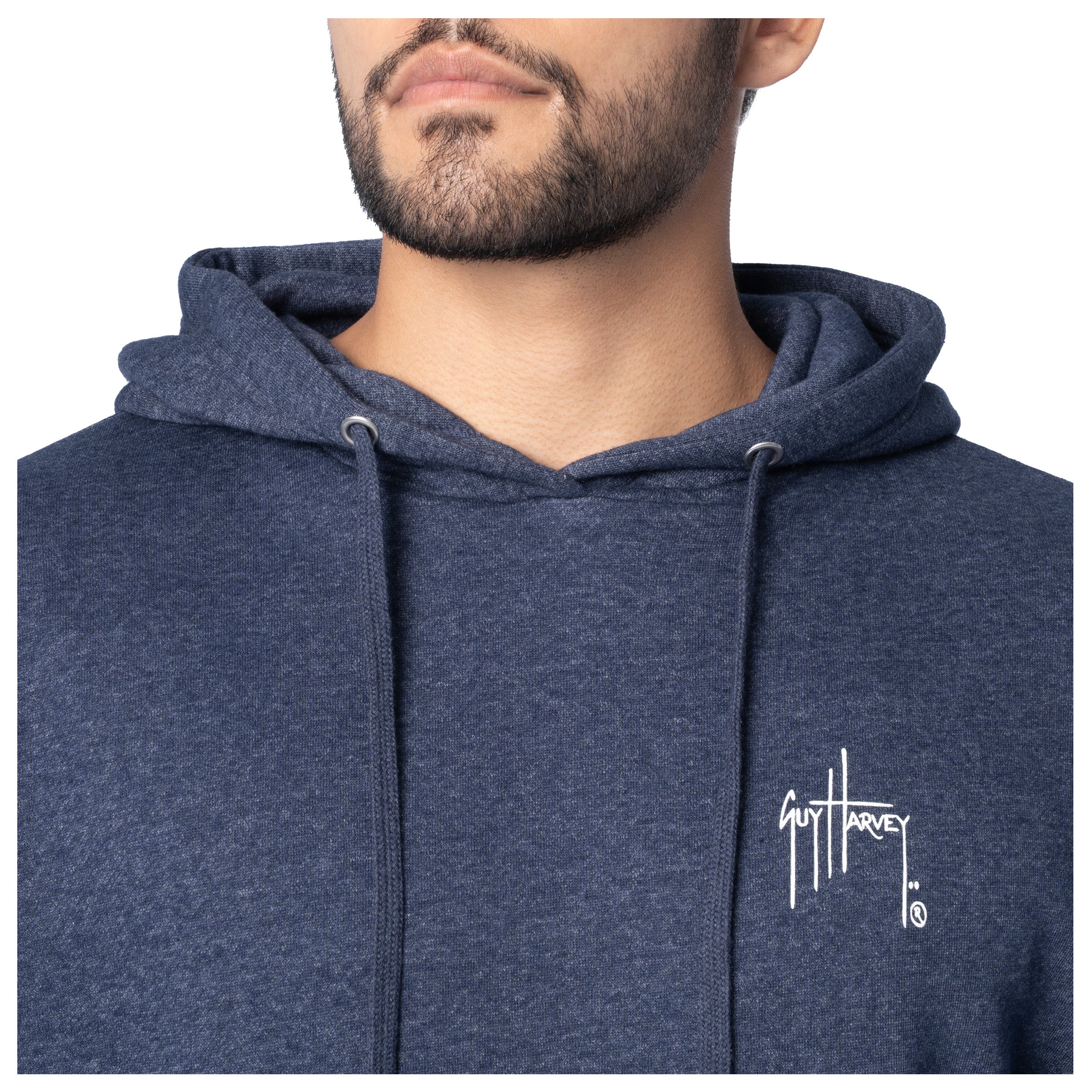 Close-up of the white Guy Harvey logo on the chest of a navy blue fishing fleece hoodie.
