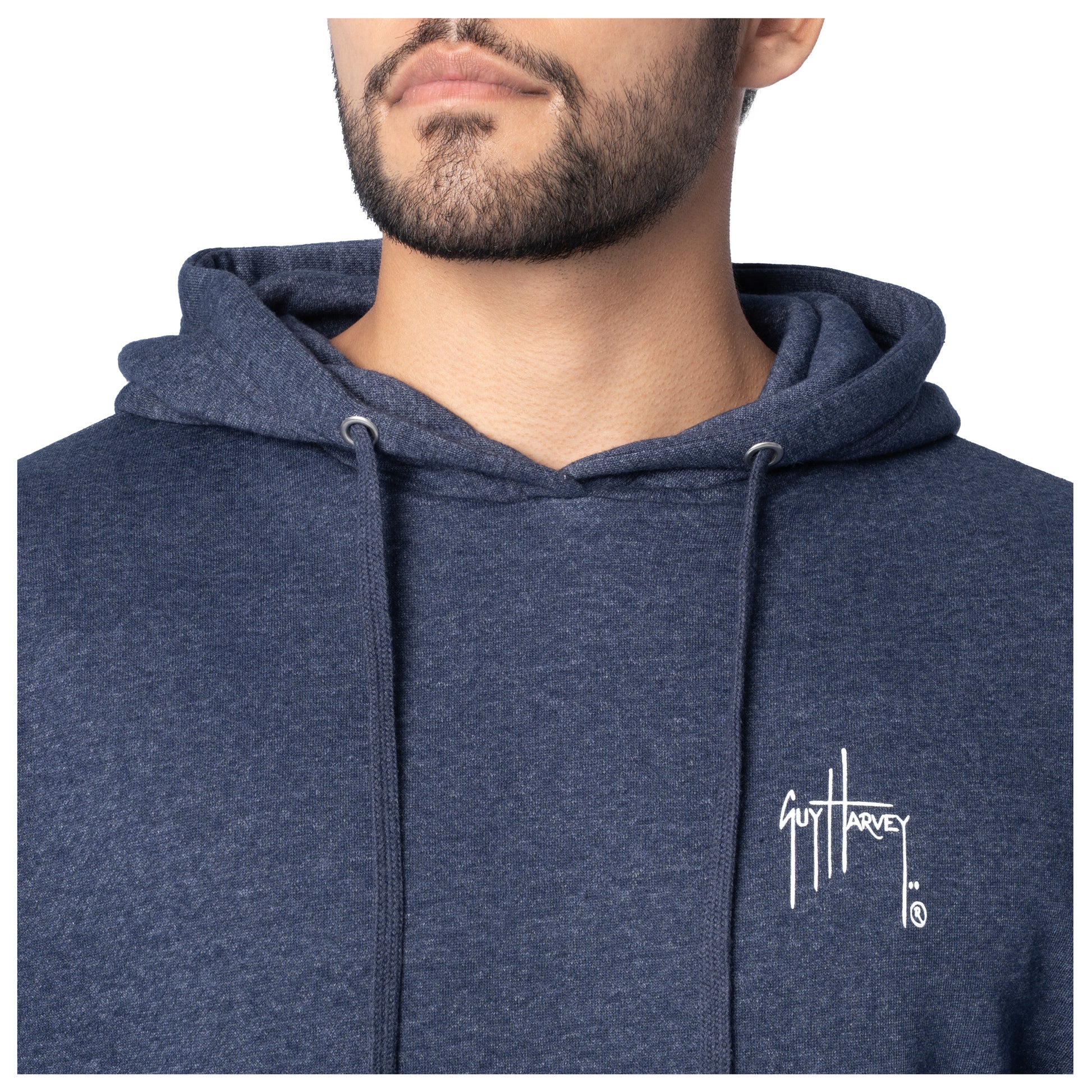 Close-up of the white Guy Harvey logo on the chest of a navy blue fishing fleece hoodie.