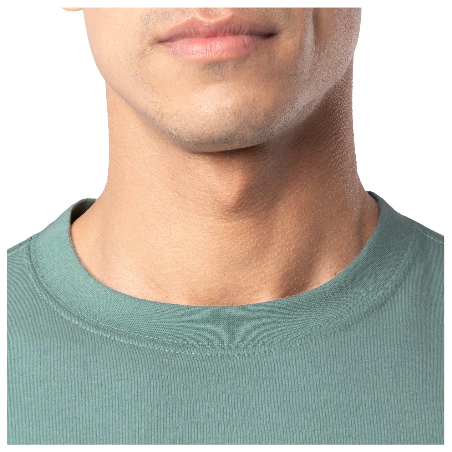 Close-up of a person wearing a green shirt with a plain background