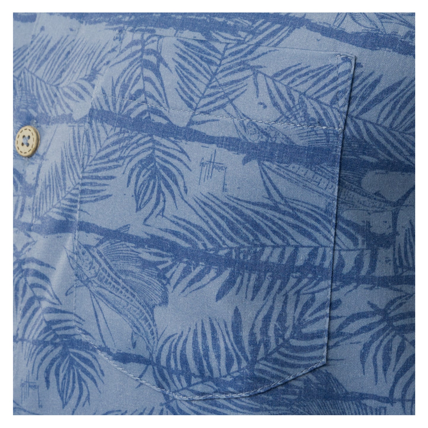 Close-up of left chest pocket on denim blue Guy Harvey Sandbar Printed Resort Shirt.