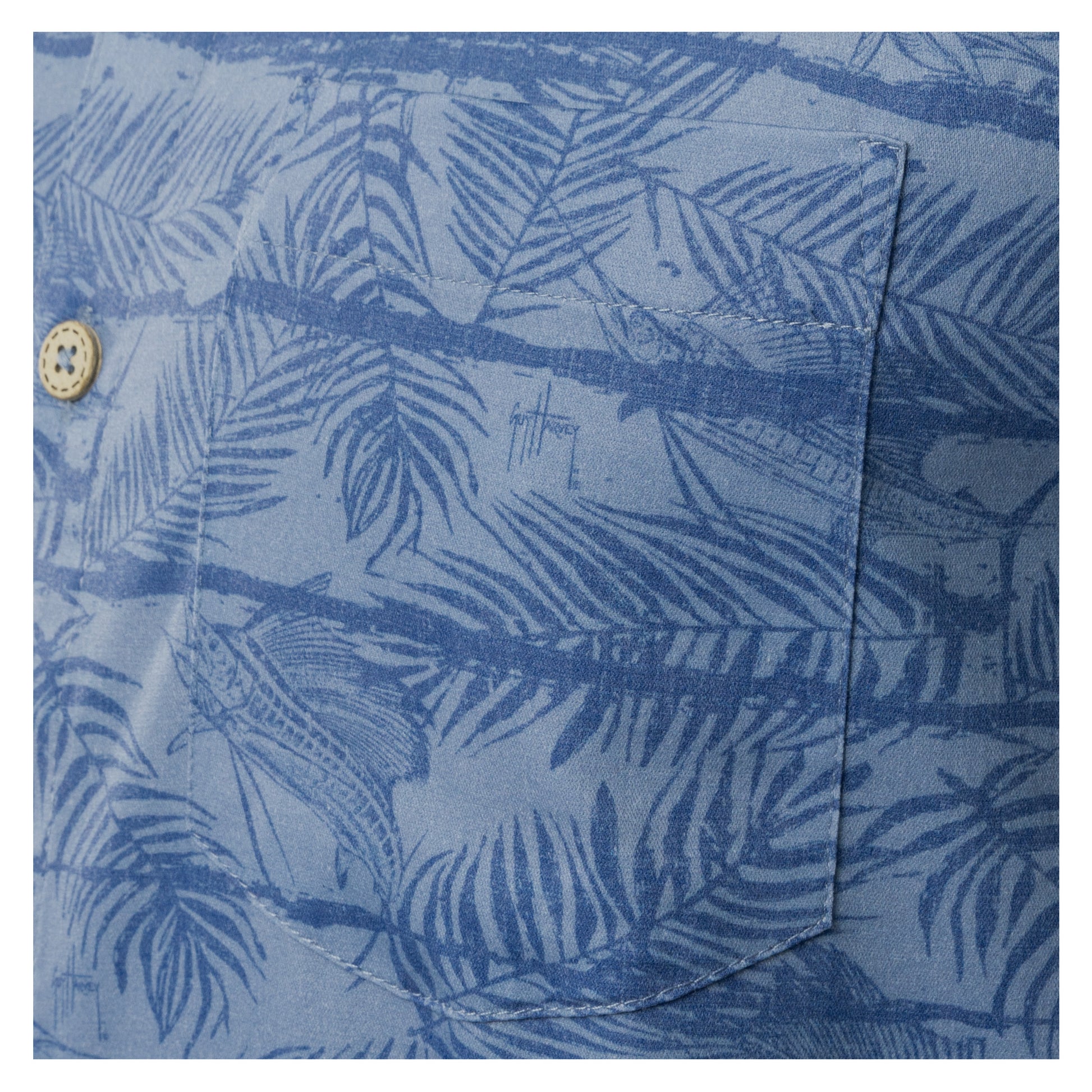 Close-up of left chest pocket on denim blue Guy Harvey Sandbar Printed Resort Shirt.