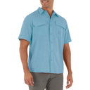 Man wearing a light blue short-sleeve shirt on a white background