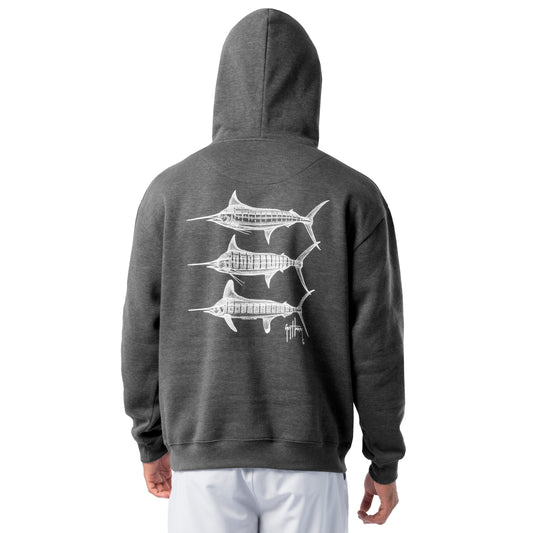 Back view of a man wearing a dark gray Guy Harvey fishing fleece hoodie featuring three white marlin line-art graphics on the back.