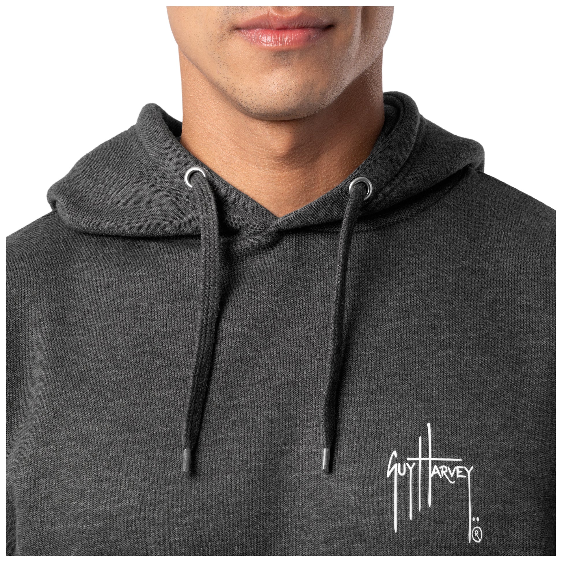 Close-up of the chest logo and hood detail on a dark gray Guy Harvey fishing fleece hoodie.