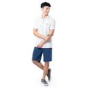 Lifestyle image of model wearing white Guy Harvey Men’s White Fleet Printed Polo Shirt with navy shorts.