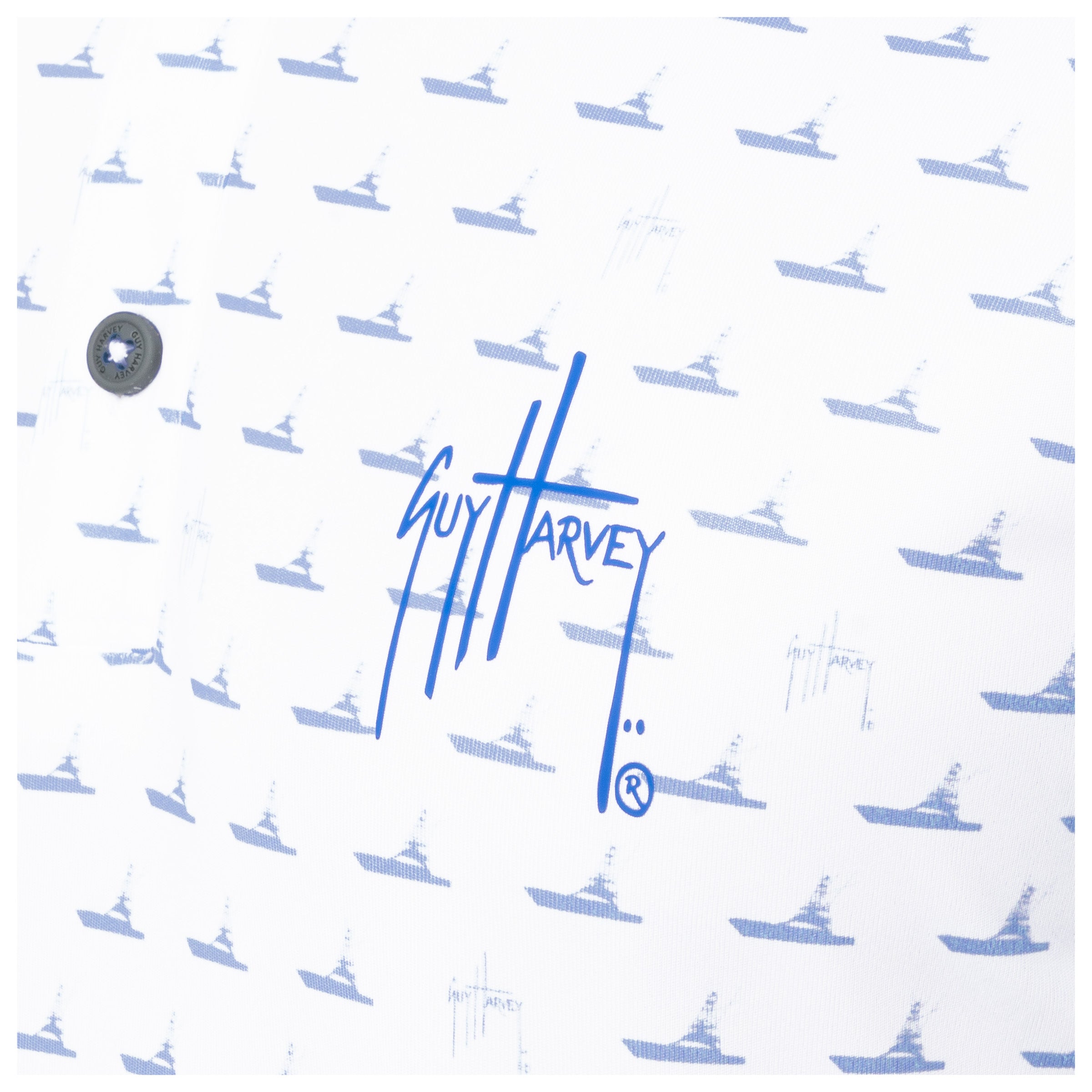 Detail of blue Guy Harvey signature logo and boat print on white performance fabric.