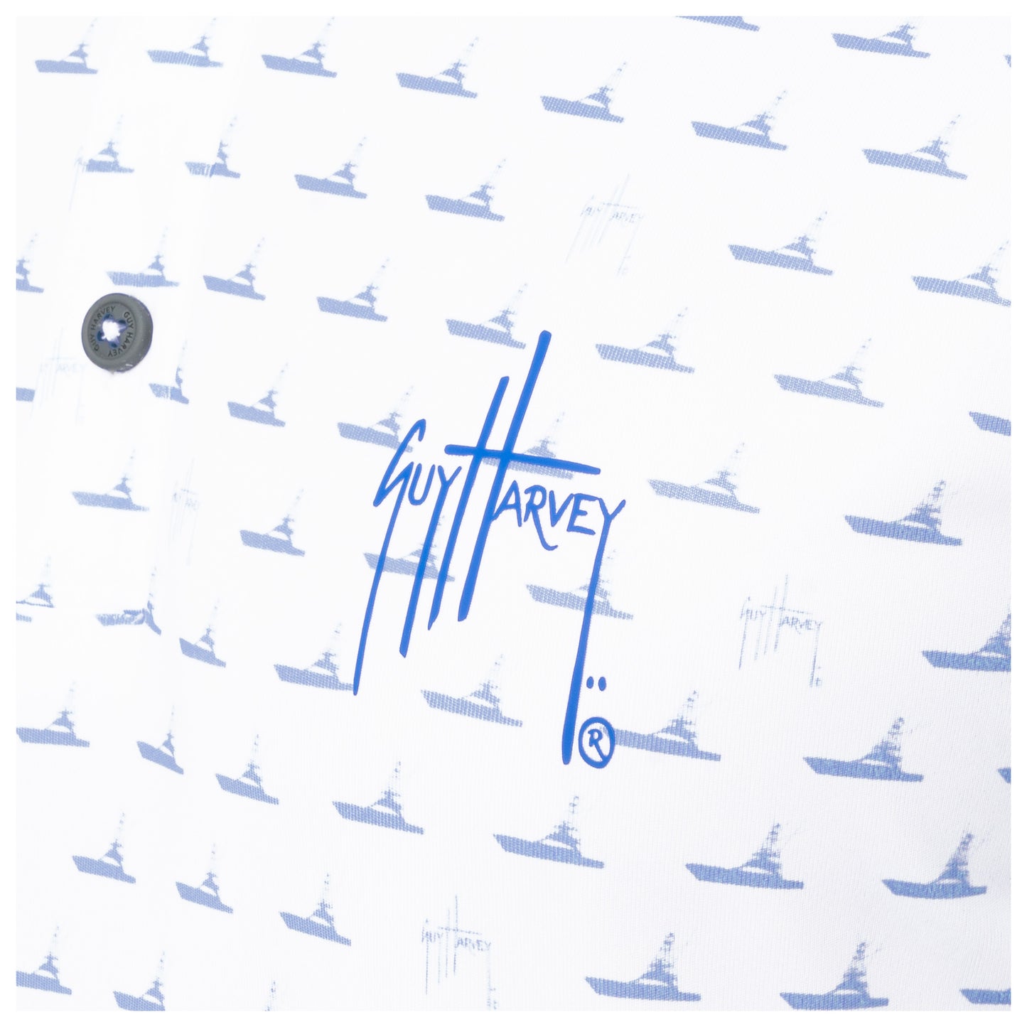 Detail of blue Guy Harvey signature logo and boat print on white performance fabric.
