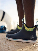 Close up of blue deck boots with an edgy yellow fish design