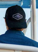 The back of a mans head with a backwards ballcap
