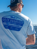 Man in cap wearing blue Guy Harvey tshirt