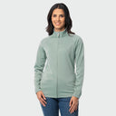 A woman modeling a blue surf full-zip fleece jacket with a mock neck collar, paired with blue jeans, against a solid light gray background.