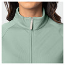 Close-up of a woman wearing a blue surf athletic quarter-zip jacket with a stand-up collar and a light gray zipper pull.