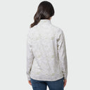 A woman viewed from the back wearing a light beige long-sleeve collared top with an allover tonal abstract pattern, paired with blue jeans, against a plain light gray studio background.