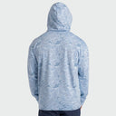 A person viewed from the back wearing a light blue hooded sweatshirt with an allover tonal cloud-like pattern, against a plain light gray studio background.