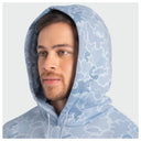 A man wearing a light blue and white camouflage-patterned hoodie, shown from the chest up against a plain light gray background.