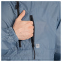 Close-up of a person's hand opening a black zipper on a light blue grid-patterned jacket.