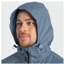 A close-up of a man wearing a light blue hooded rain jacket against a light gray background.