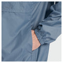 Close-up of a person wearing a lightweight blue jacket with a fine checkered pattern, showing the sleeve cuff and hand in a pocket against a light gray background.