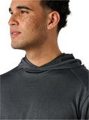 Man wearing a dark gray hoodie against a plain background