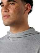 Close-up of a person wearing a gray hoodie against a light background