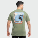 A male wearing an olive green Guy Harvey Threadcycled T-Shirt with a freshwater graphic