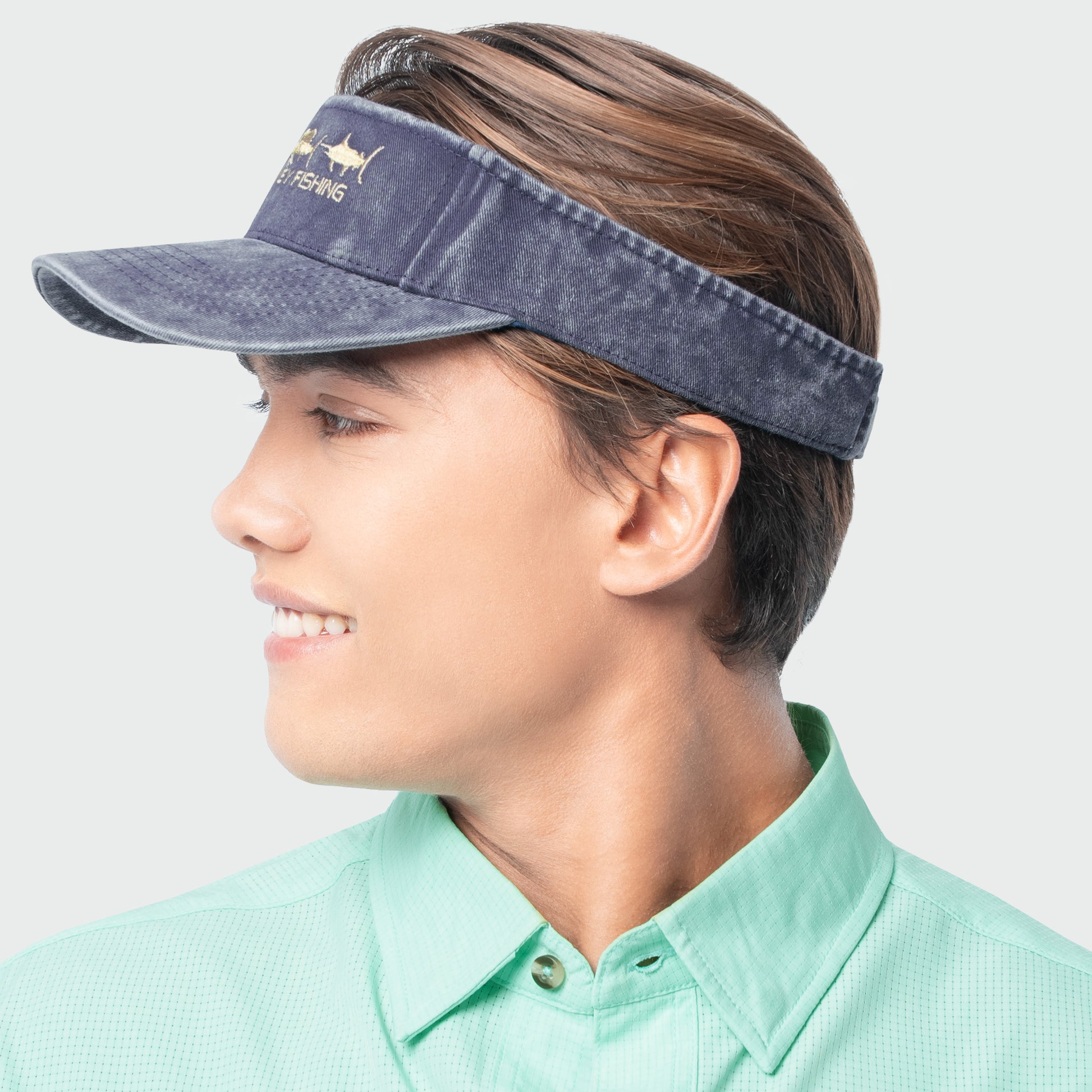 Sideview of a person wearing a blue visor with a brand logo on a light gray background