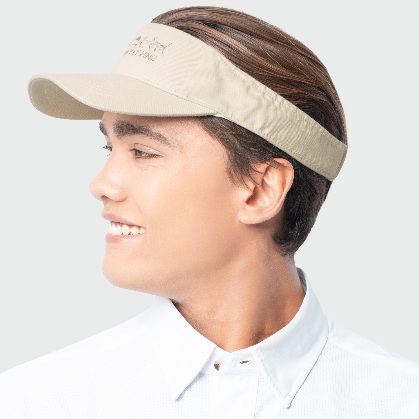 Person wearing a beige visor on a white background