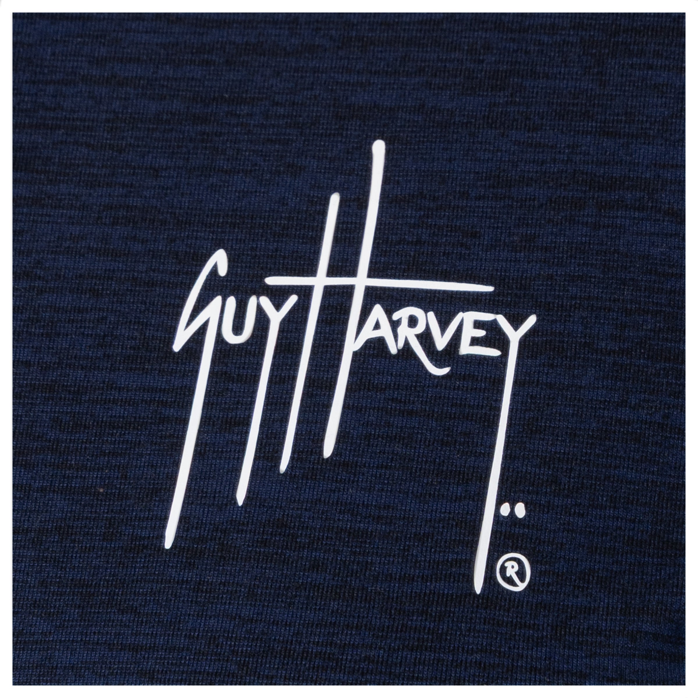 Guy Harvey chest logo close-up in white on navy fabric