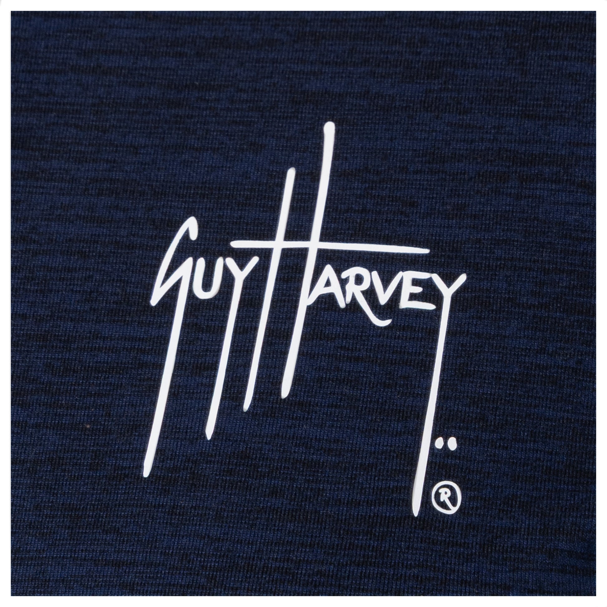 Guy Harvey chest logo close-up in white on navy fabric