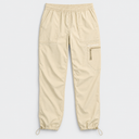A women Beige fishing pants with an elastic waistband, side technical pocket with a zipper, and drawstring ankle cuffs, shown flat on a light gray background.