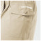 Close-up of a beige utility pocket on a pair of pants with 'GUY HARVEY' printed in white on the flap, featuring a matching button closure.
