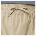 Close-up of beige drawstring skort showing the elastic waistband and matching drawstring bow.