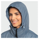 A smiling woman wearing a light blue hooded rain jacket with a textured pattern, shown against a plain light gray background.
