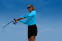 Woman casting a line in performance fishing wear