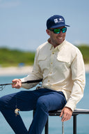 man wearing a beige Guy Harvey Eco Angler Long Sleeve fishing shirt